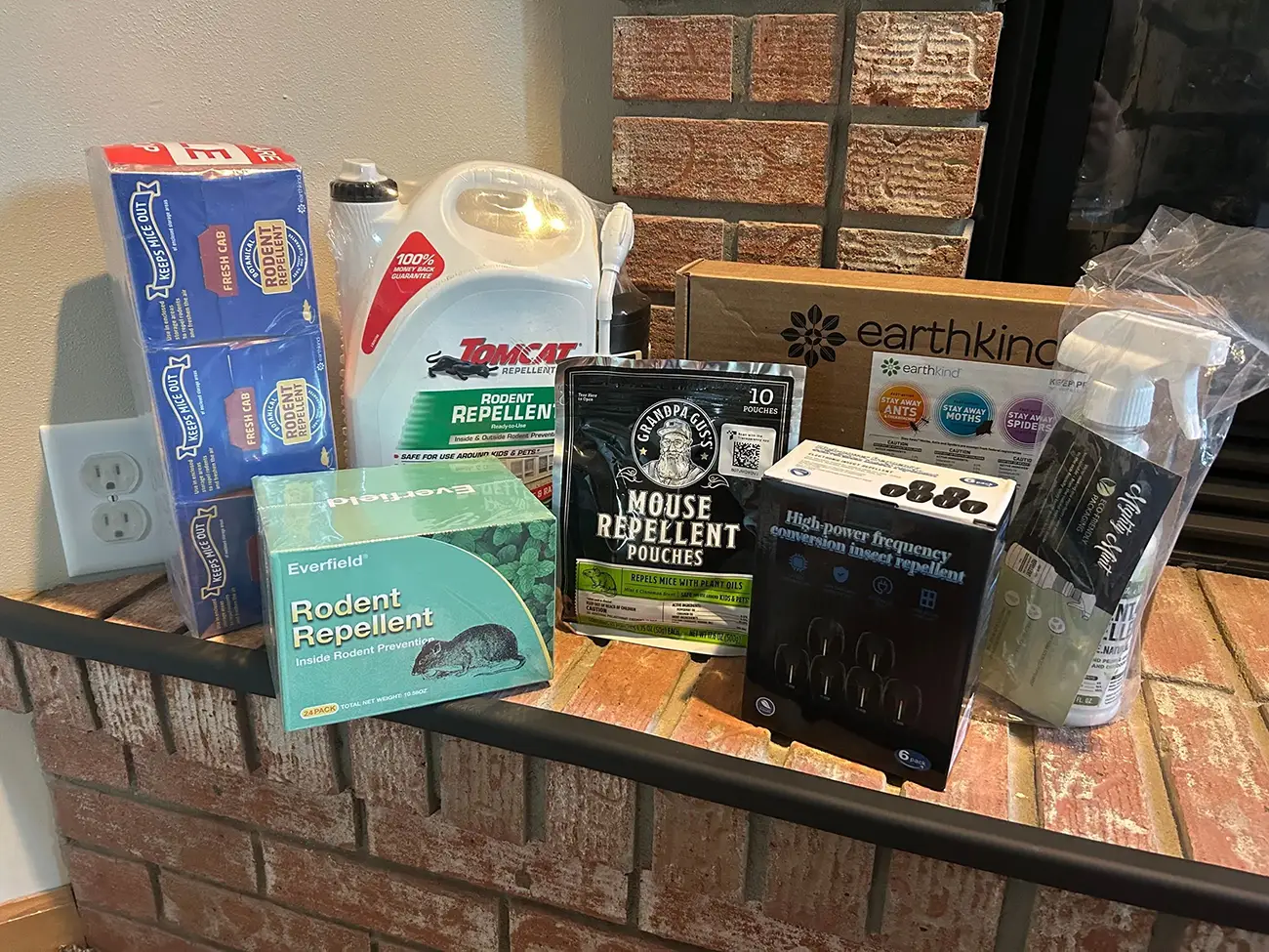 All tested rodent repellents displayed together on the fireplace mantel
